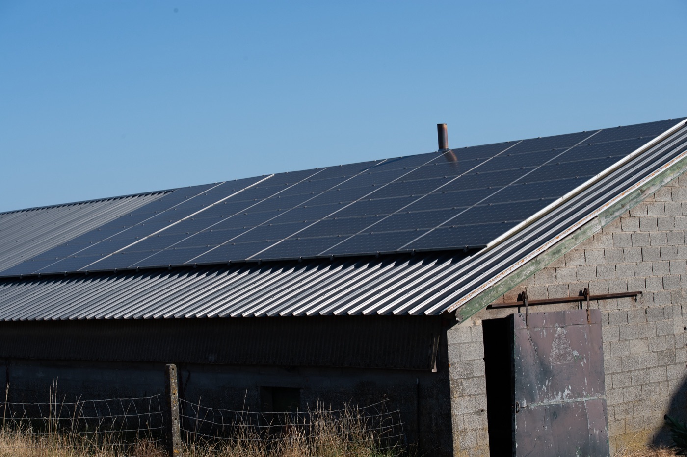 Solar panels across the full roof of a farm barn